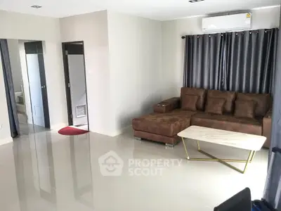Spacious living room with modern sofa and elegant curtains