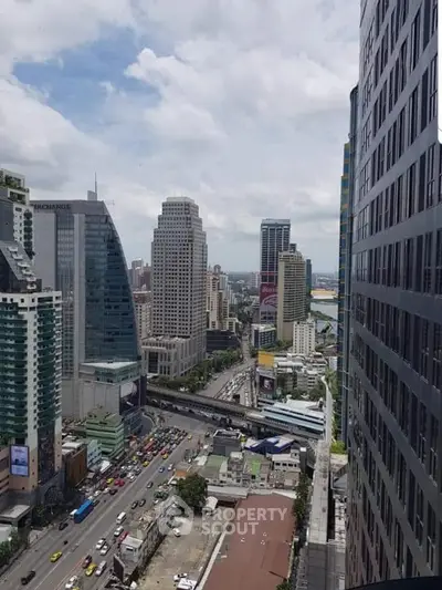 Stunning cityscape view from high-rise building showcasing urban skyline and bustling streets.