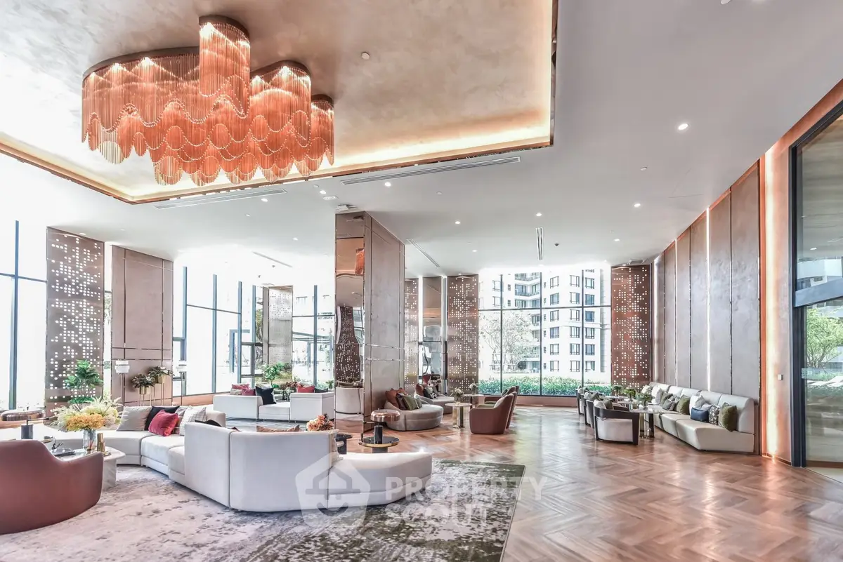 Luxurious modern living room with elegant chandelier and spacious seating area.