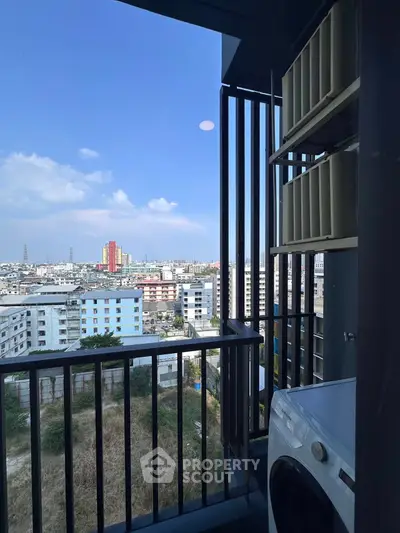Stunning city view from modern balcony with washing machine, perfect for urban living.
