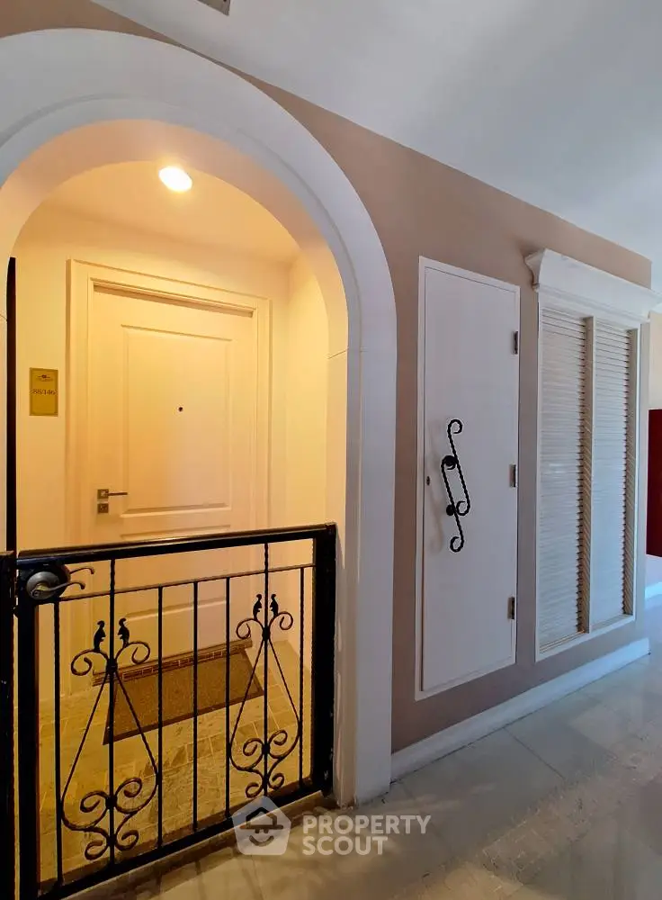 Charming apartment entrance with elegant iron gate and warm lighting