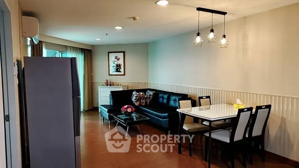 Spacious living room with modern decor and dining area in a cozy apartment.