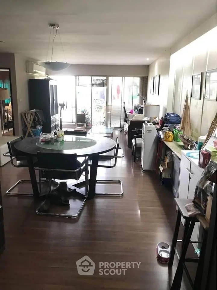 Spacious living room with modern dining set and ample natural light