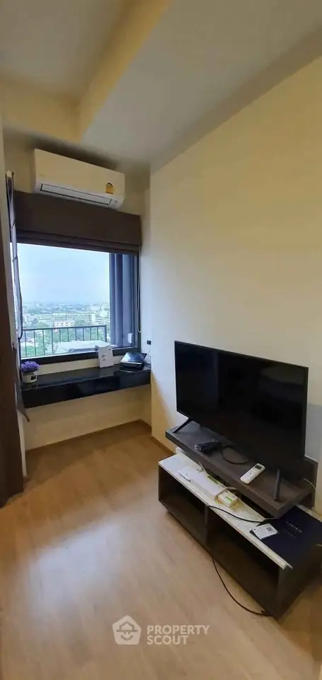 Cozy living room with TV and scenic window view