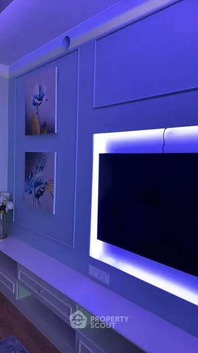 Modern living room with stylish LED-lit TV wall and elegant decor