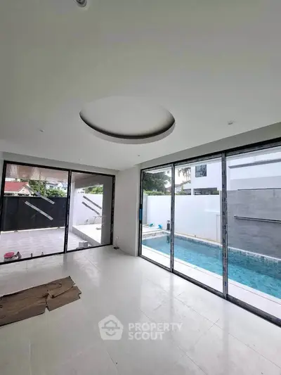 Luxurious modern living room with pool view and large glass doors