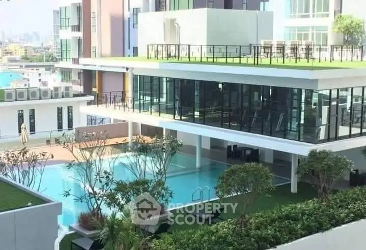 Luxurious modern building with rooftop garden and pool view, perfect for urban living.