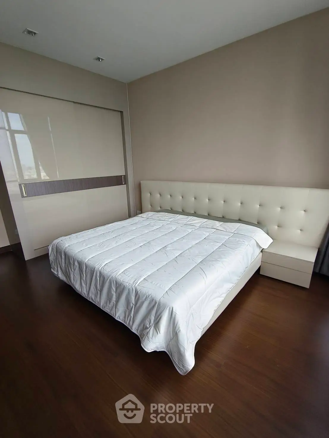 Spacious bedroom with modern design and elegant furnishings in a luxury apartment.