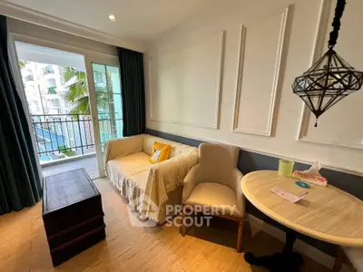 Charming living room with elegant decor and balcony view, perfect for relaxation.