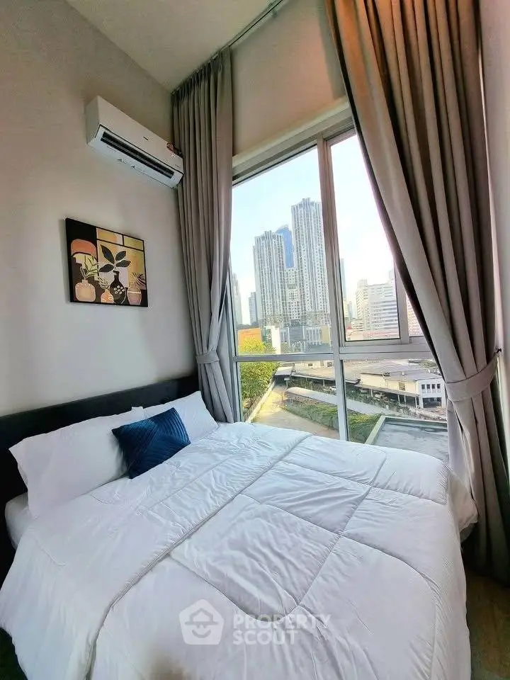 Modern bedroom with city view and large window, featuring cozy bedding and elegant curtains.