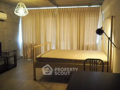 Modern bedroom with minimalist design and natural lighting, featuring a stylish bed and contemporary decor.