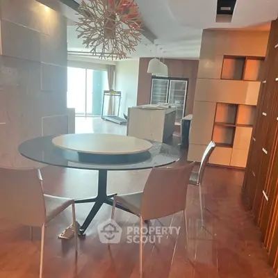 Modern dining area with stylish chandelier and open kitchen layout