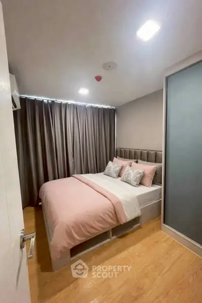 Cozy bedroom with modern decor and soft lighting, featuring a comfortable bed and stylish curtains.