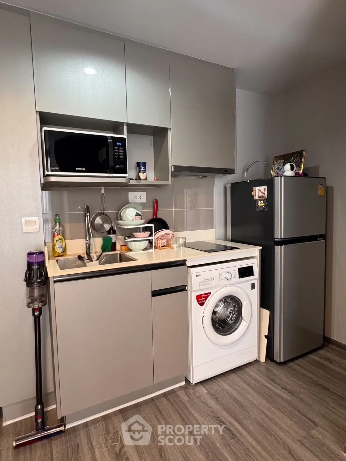 Modern compact kitchen with washing machine and sleek appliances