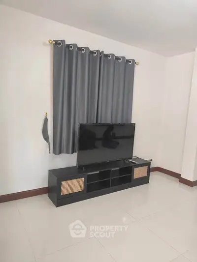 Modern living room with sleek TV stand and elegant curtains