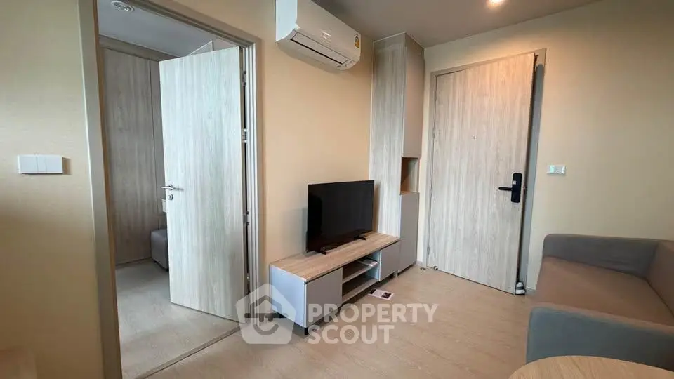 Modern living room with air conditioning and stylish wooden furniture