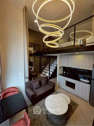 Luxurious modern living room with high ceilings and stylish lighting in a duplex apartment.