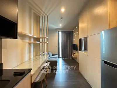 Modern living room with sleek furniture and open layout, featuring a cozy sofa and stylish shelving.