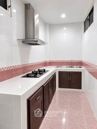 Modern kitchen with sleek gas stove and stylish cabinetry in a compact layout.