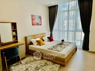 Modern bedroom with large window and stylish decor in high-rise apartment