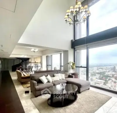 Luxurious high-rise living room with panoramic city views and elegant decor.