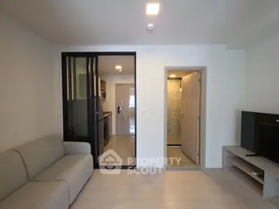 Modern living room with sleek kitchen and cozy sofa