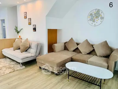 Stylish living room with modern beige sectional sofa and chic decor