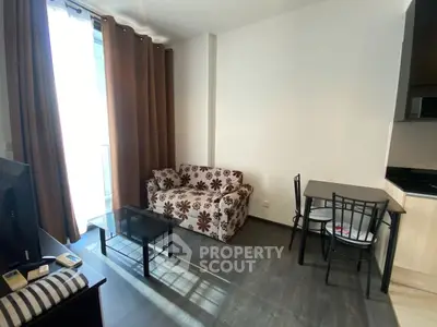 Cozy living room with floral sofa, glass coffee table, and dining set near large window.