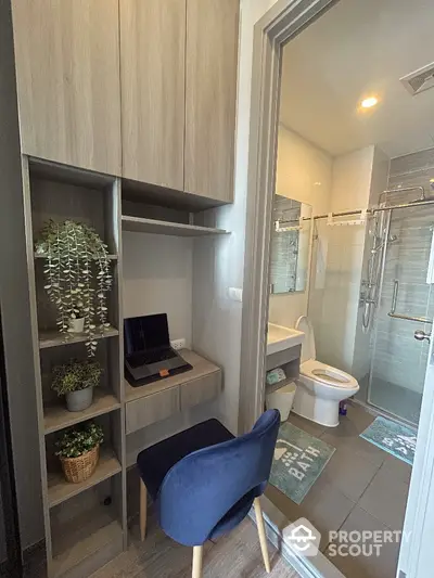 Modern compact bathroom with adjacent study nook featuring sleek design and efficient use of space.