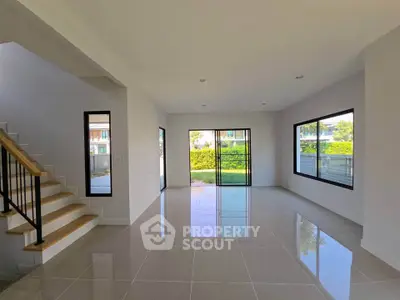 Spacious modern living room with large windows and garden view