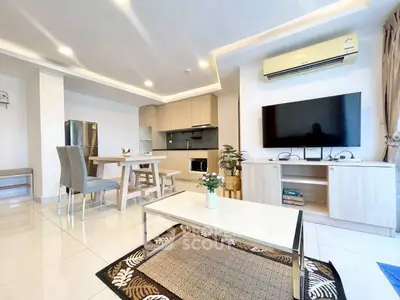 Modern open-plan living room with dining area and sleek kitchen design.