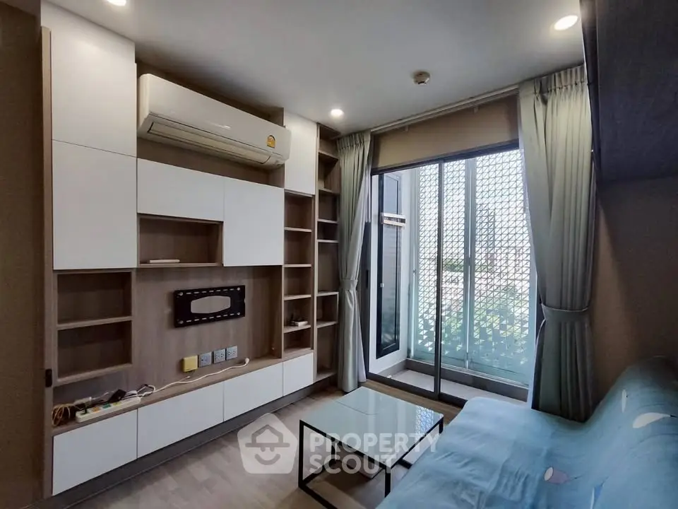 Modern living room with sleek built-in storage and balcony access