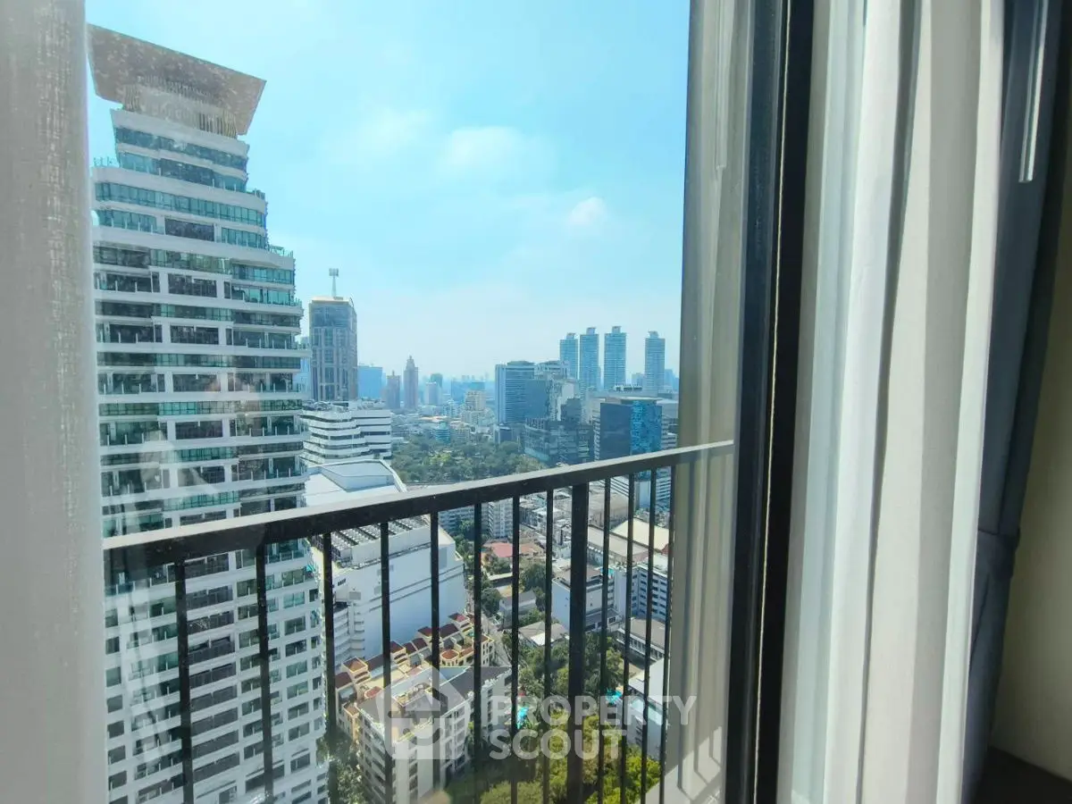 Stunning cityscape view from high-rise apartment balcony with modern architecture.