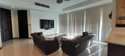 Spacious modern living room with sleek furniture and large windows
