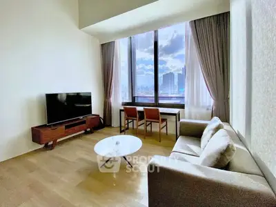 Spacious living room with modern furniture and stunning city view through large windows.
