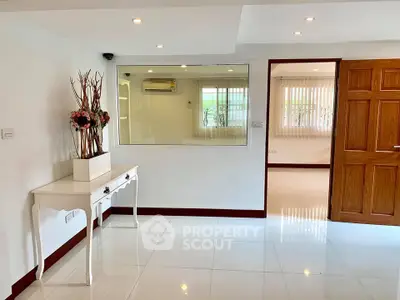 Spacious and elegant interior with modern decor and large mirror, perfect for stylish living.