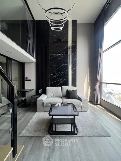 Luxurious modern living room with high ceilings and large windows in a stylish apartment.