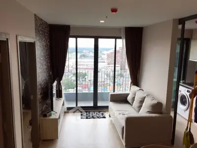 Modern living room with balcony view and washing machine