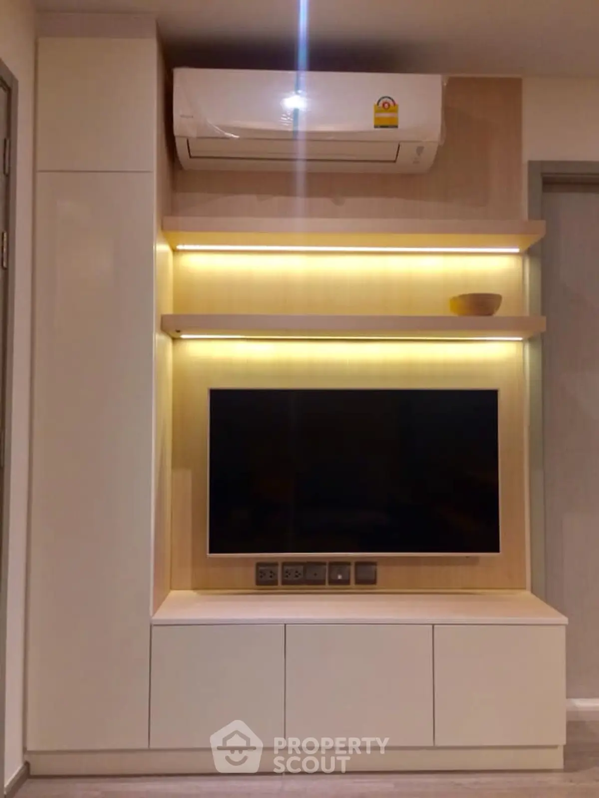 Modern living room with sleek TV unit and air conditioning