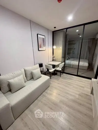 Modern living room with glass partition and cozy bedroom view