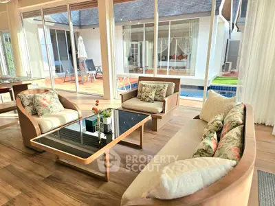 Elegant living room with pool view and stylish furniture in modern home