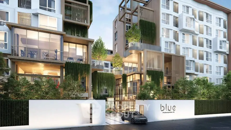 Modern condominium exterior with lush greenery and sleek architectural design.