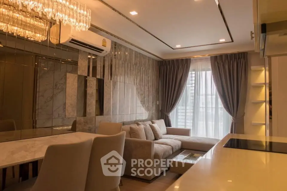 Luxurious living room with elegant decor and large window in modern apartment.