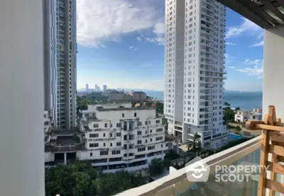 Stunning high-rise apartment view with ocean backdrop and modern architecture.