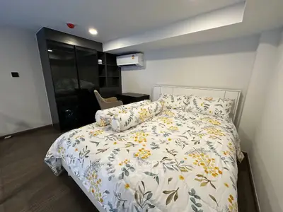 Modern bedroom with stylish decor and air conditioning in a contemporary apartment.