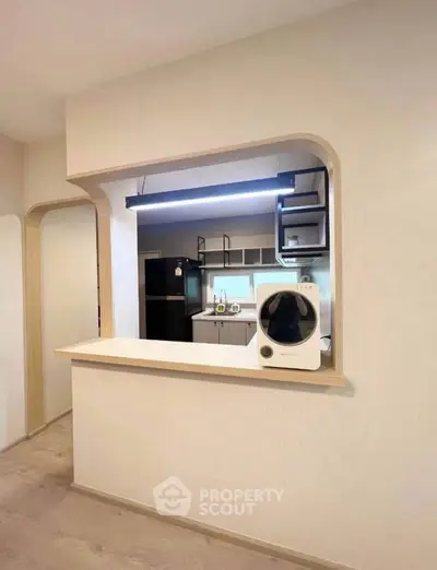 Modern kitchen with open layout and sleek appliances, featuring a stylish countertop and contemporary design.