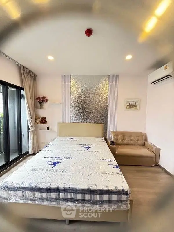 Modern bedroom with stylish decor and large window for natural light