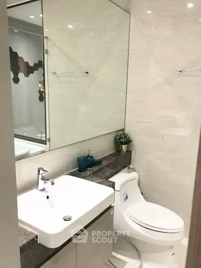 Modern bathroom with sleek fixtures and elegant marble accents.