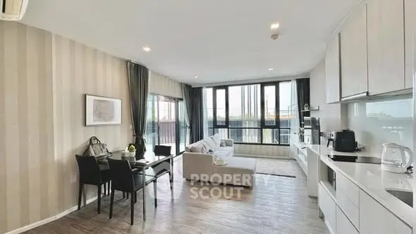 Spacious modern living room with open kitchen and large windows