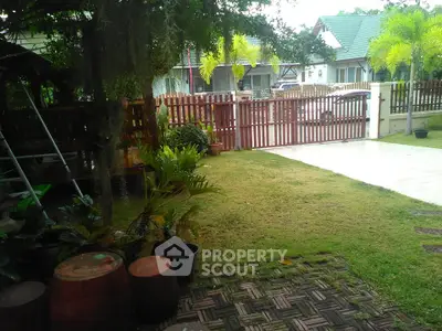 Charming garden view with lush greenery and cozy outdoor seating area.